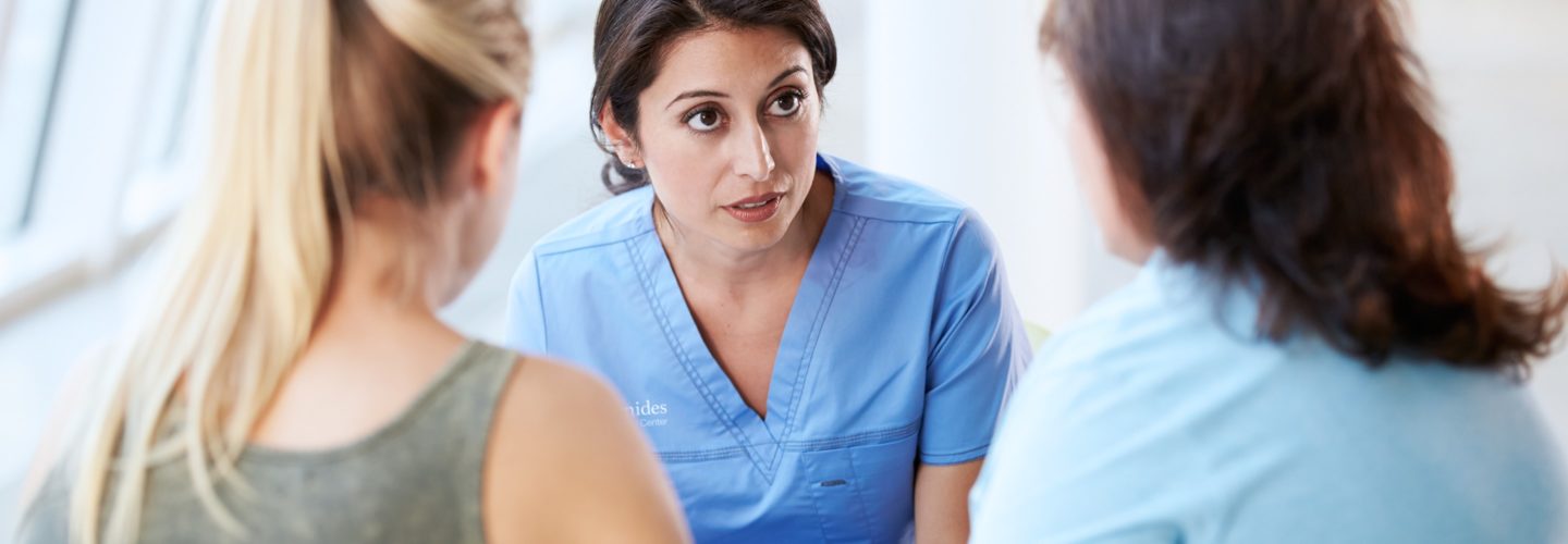 Healthcare worker talks to patient