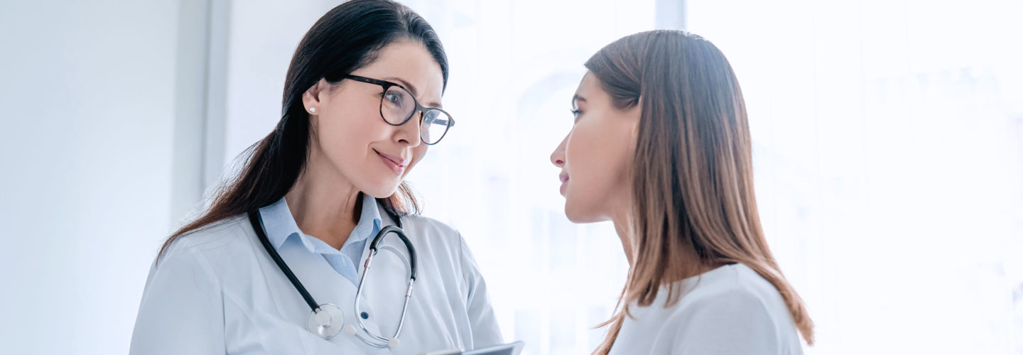 Gynecologist speaking with patient