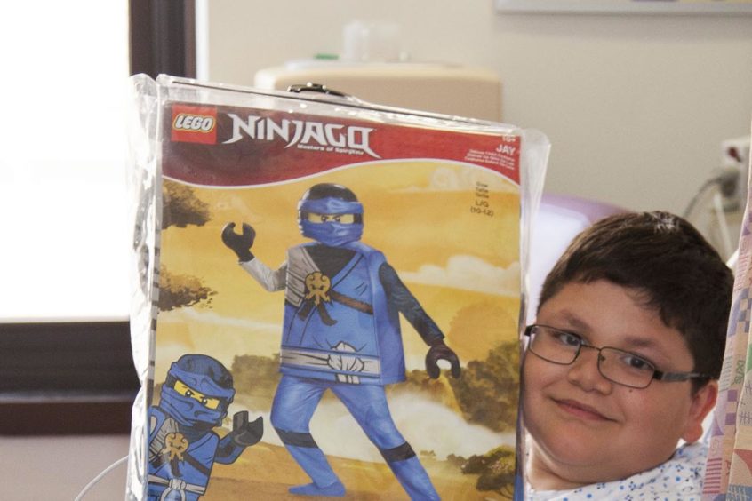 child with costume in package