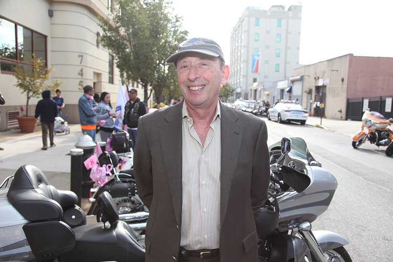 man standing in front of motorcycle