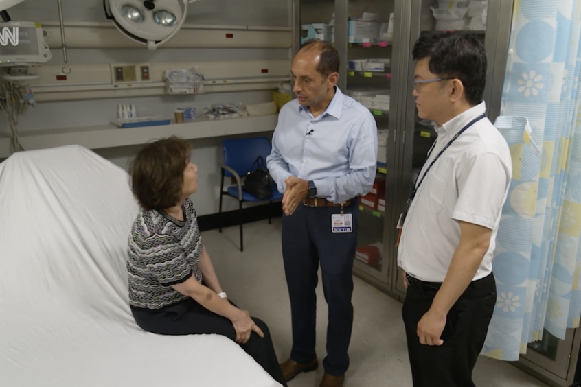 Medical team speaking with patient in ER exam area