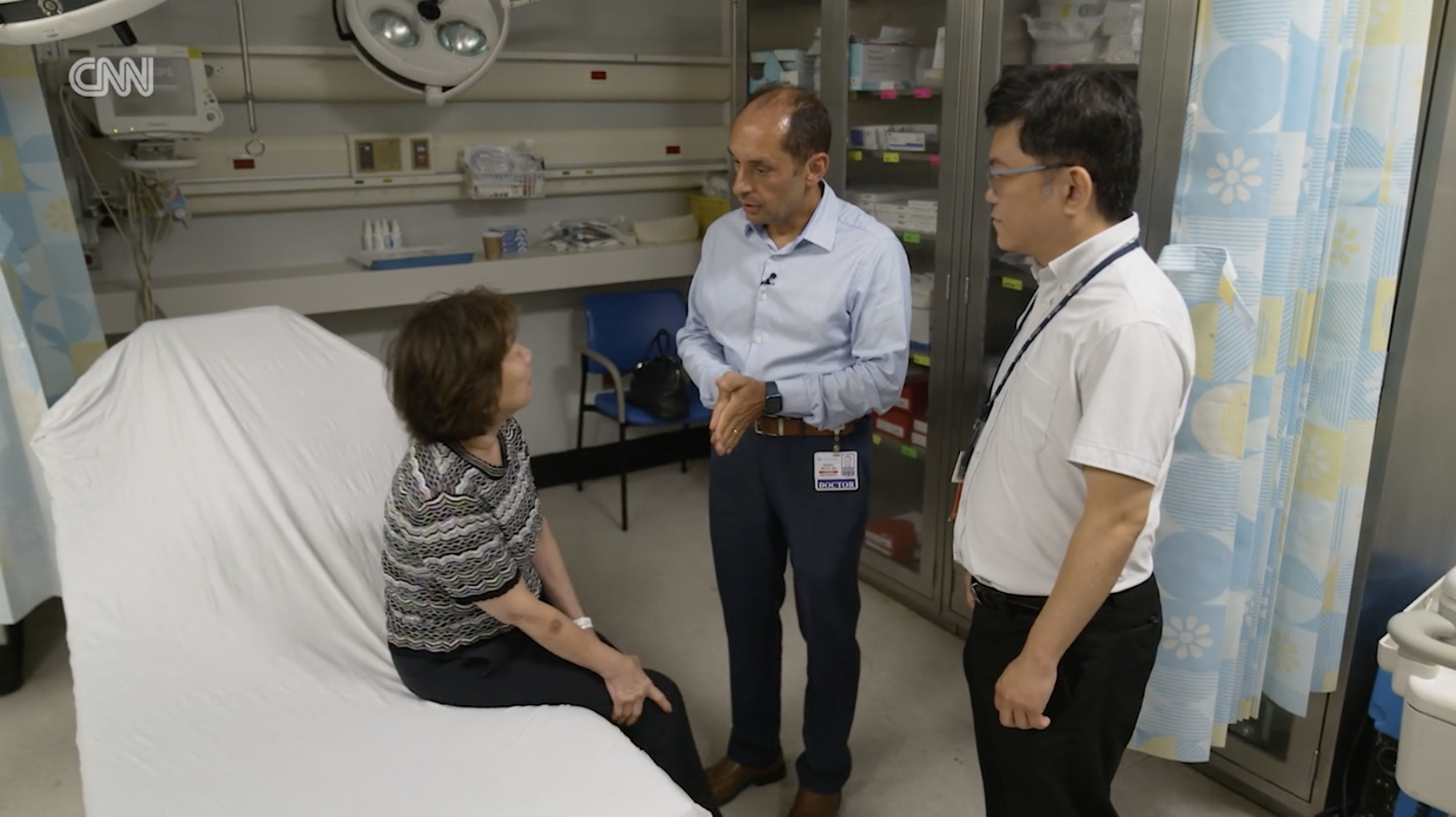 Medical team speaking with patient in ER exam area