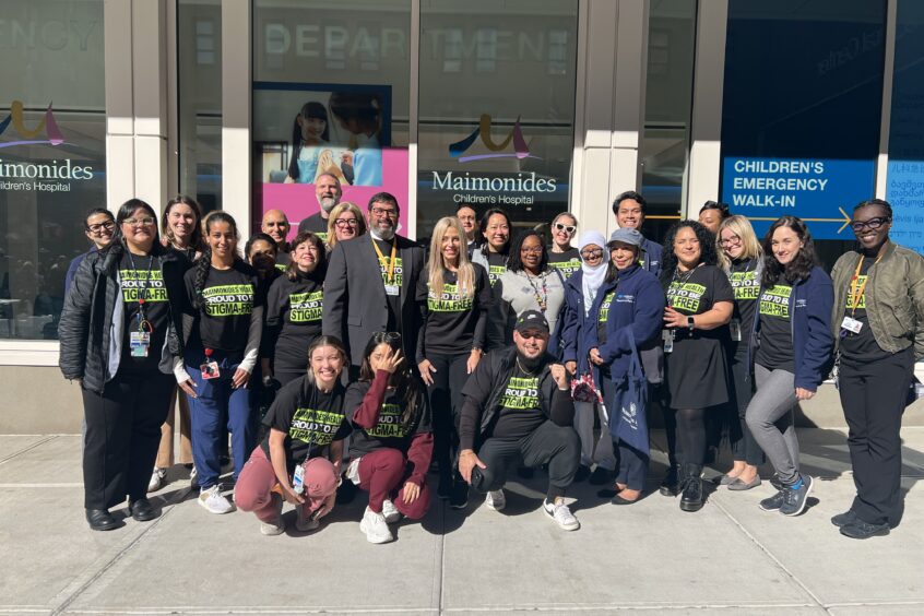 Psychiatry team smiling and posing for photo outside Pediatric ED