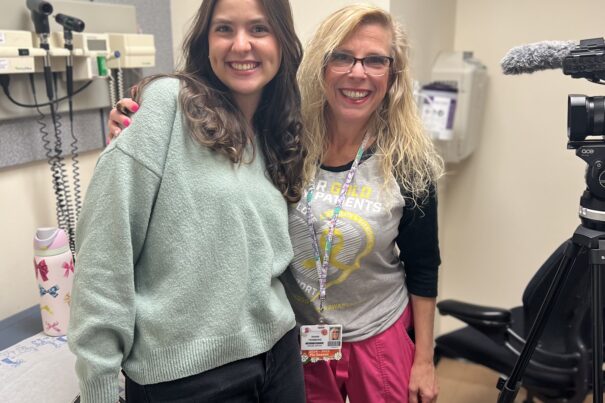 Briana and Feinberg smiling and posing together in exam room