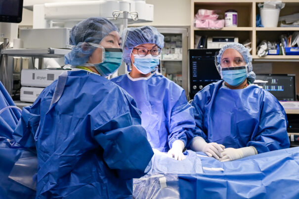 Dr. Yeonjoo Cho, Dr. Jennie Kim, and Dr. Gladys Pinto performing abdominal surgery