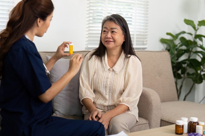 Female asian doctor speaking with female Asian patient